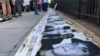 Los rostros de los presos del 11J, en una vigilia por el aniversario de las protestas, en Washington, DC.
